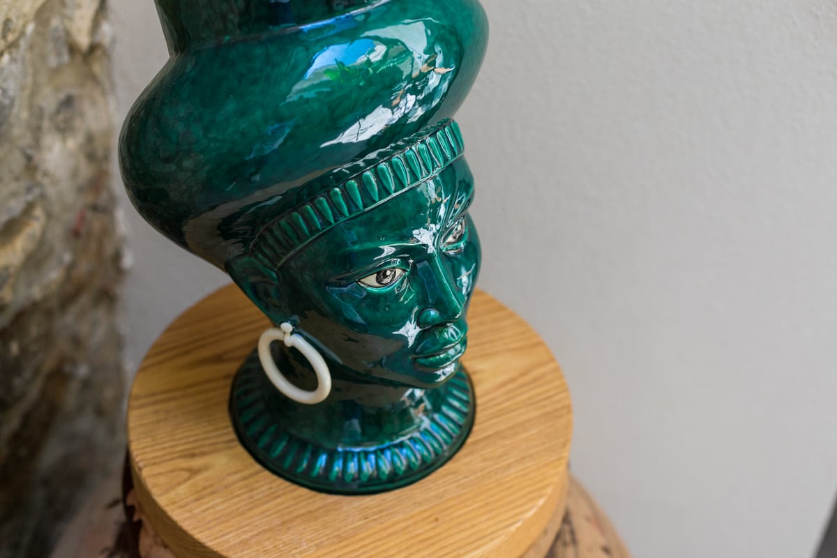 A close view of the green ceramic Moor’s head.